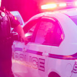 Police officer arresting a young man