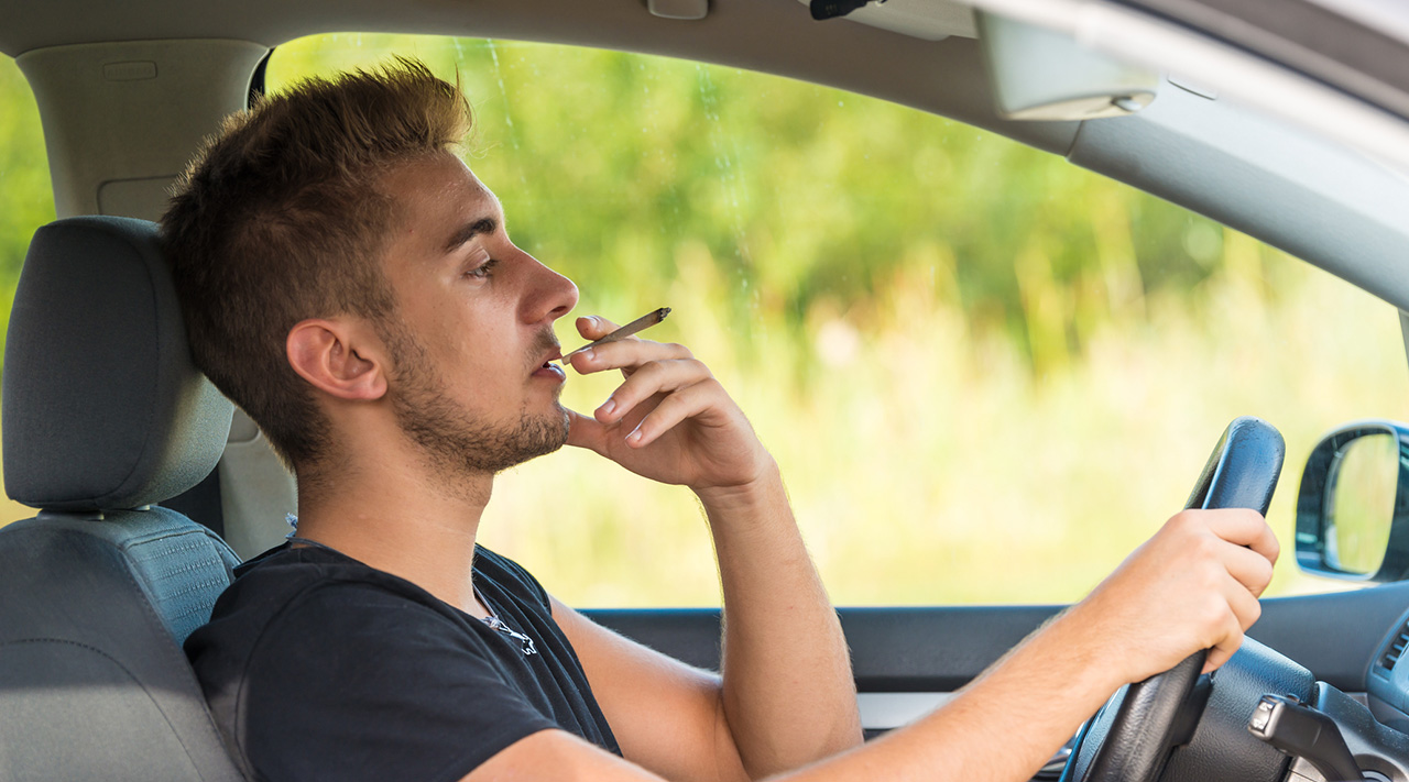 man-smoking-marijuana-while-driving